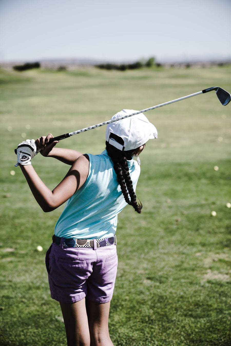 Woman playing golf on a sunny course