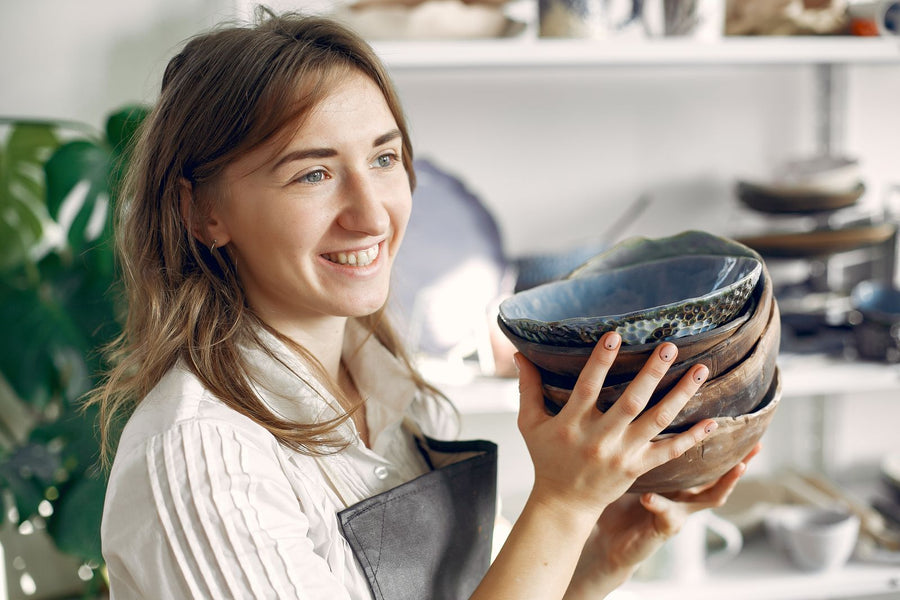 Artisan holding handmade ceramic bowls